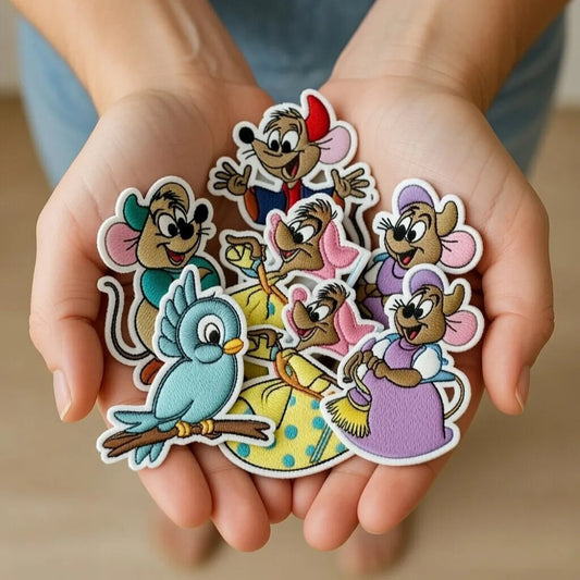 Hands Holding Collection Of Adorable Cinderella Gus, Jaq, Birds Patches