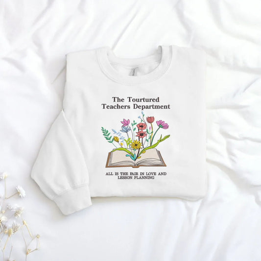White Sweatshirt Showing Colorful Book Bloom And Lesson Quote Embroidery
