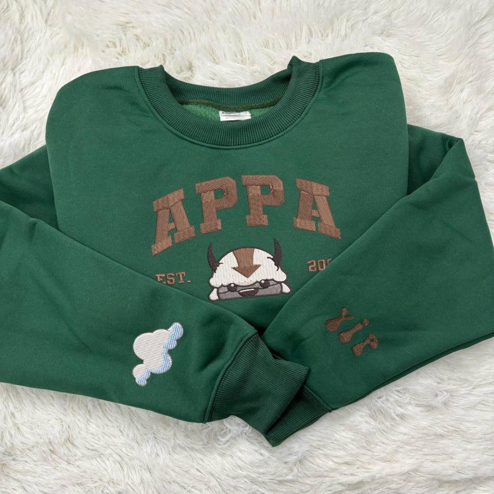 Green sweatshirt with Appa embroidery and cloud sleeve.