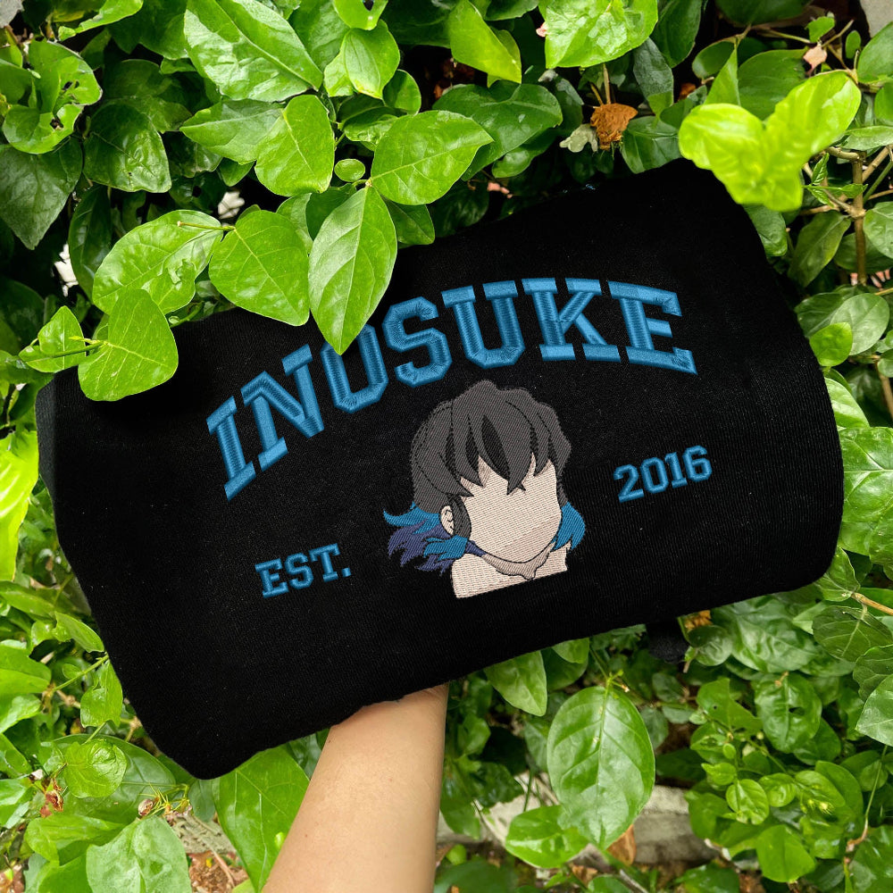 Black Inosuke Est.2016 blue lettering sweatshirt on lush foliage