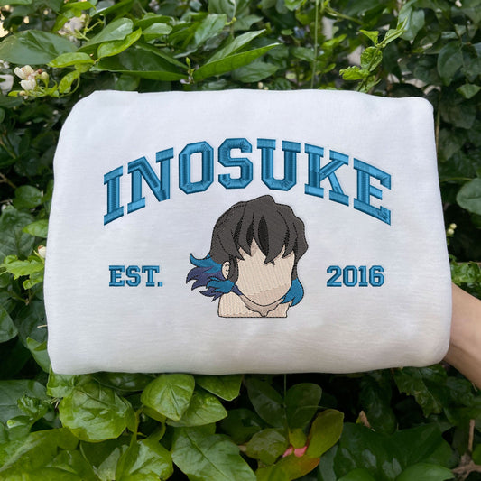 White Inosuke Hashibira Est.2016 turquoise embroidery among green leaves