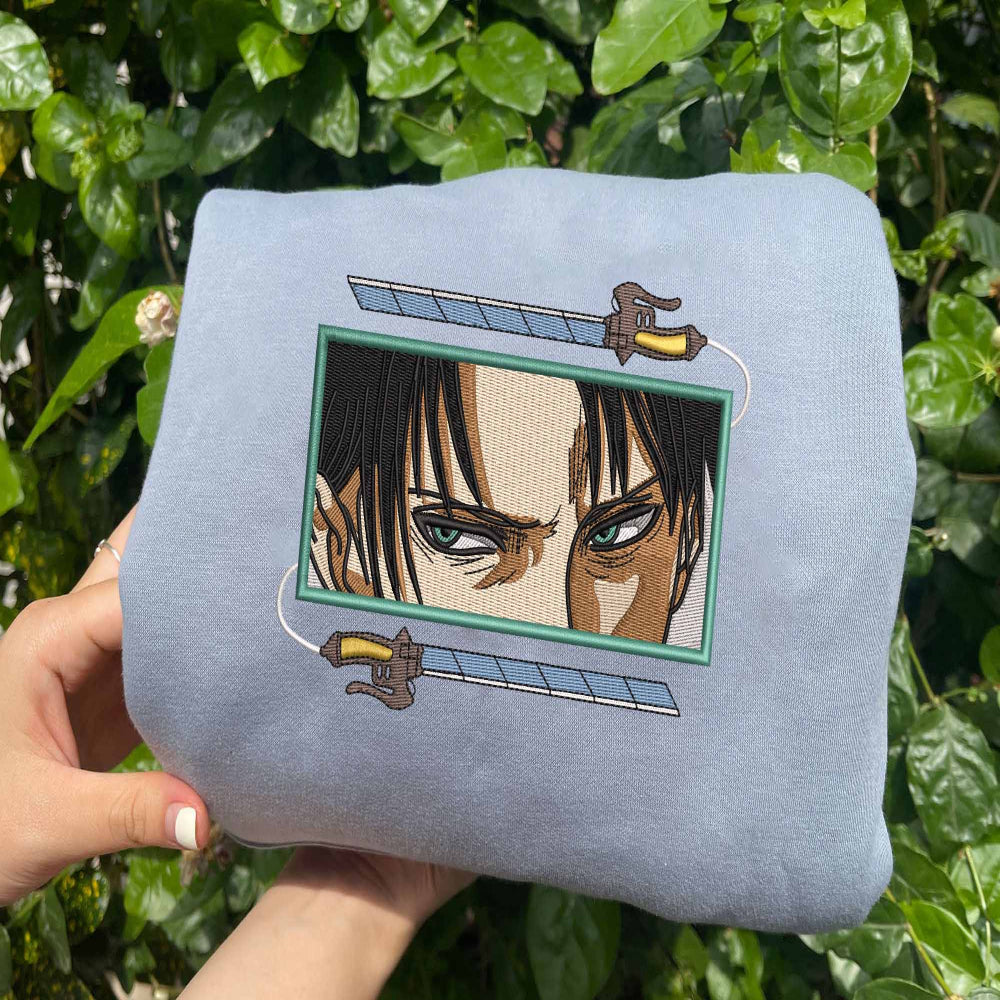 Light blue Levi ODM blades sweatshirt held outdoors greenery