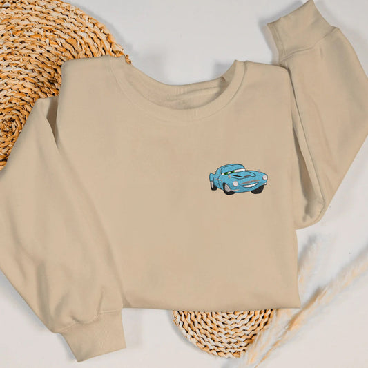 Sand sweatshirt with embroidered Finn McMissile on straw mat