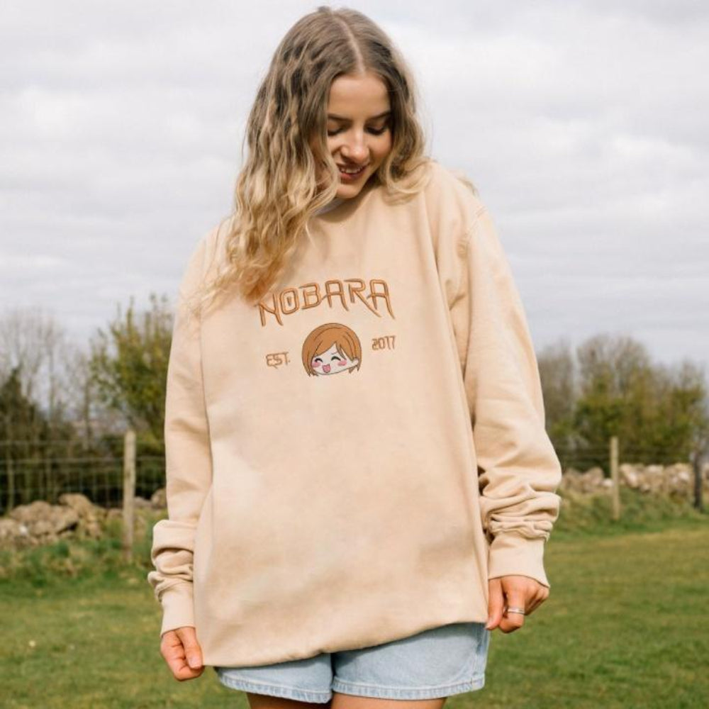 Sand Nobara Est.2017 embroidered sweatshirt on green leaves