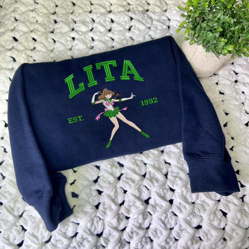 Navy Lita Jupiter Est.1992 sweatshirt on textured blanket