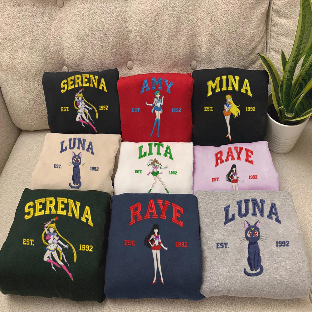 Full Sailor Moon character sweatshirt collection on beige sofa