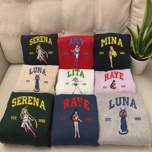 Full Sailor Moon character sweatshirt collection on beige sofa