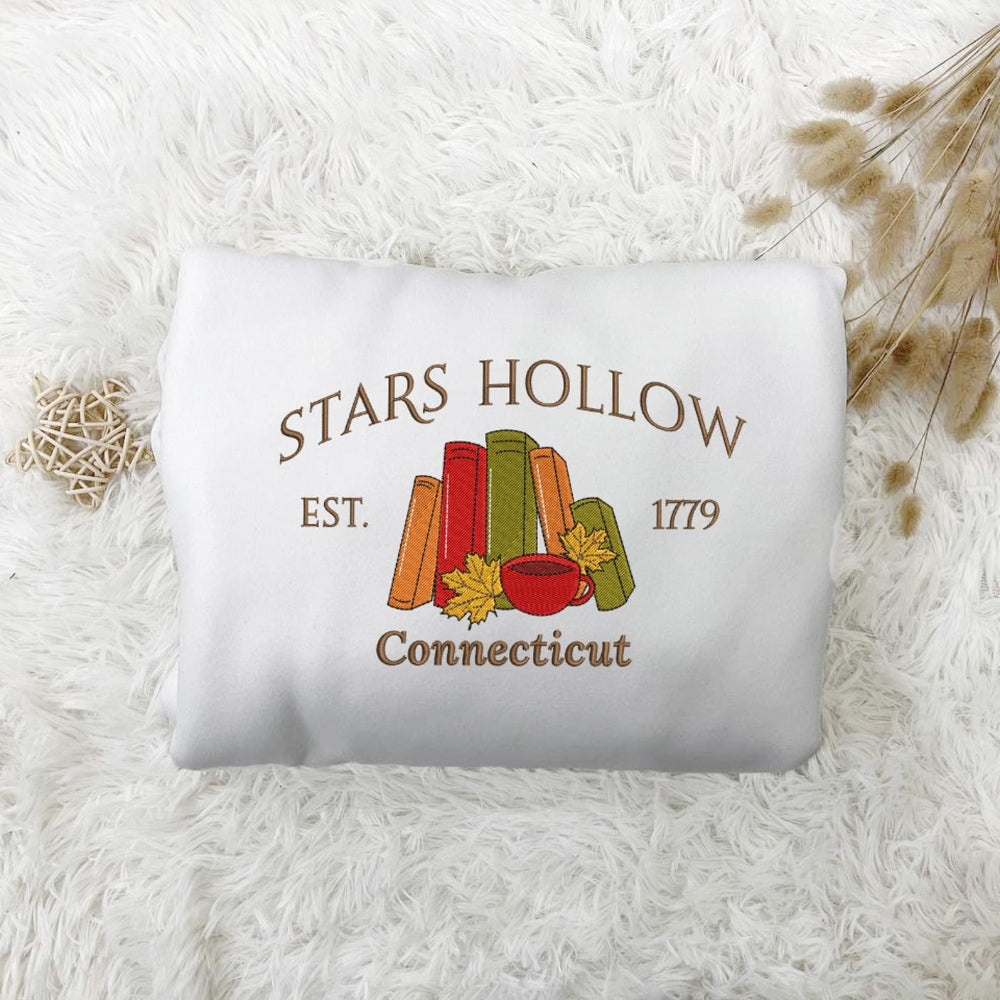 White Stars Hollow Est.1779 books & coffee sweatshirt on fluffy rug