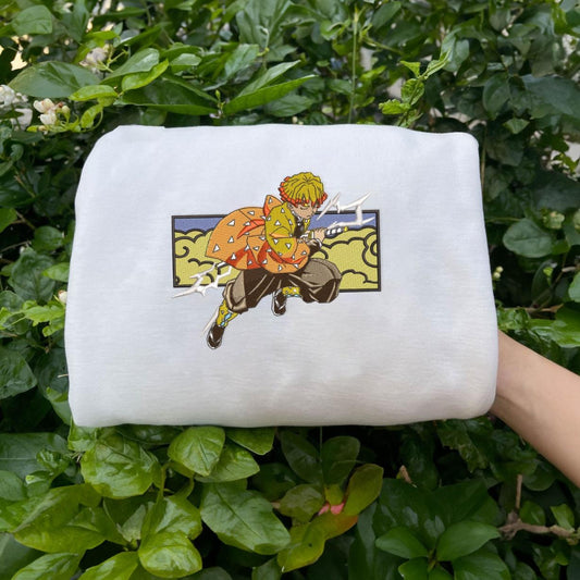 White Zenitsu Thunder Breathing embroidered sweatshirt on green leaves