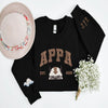 Folded black crewneck, gold “APPA 2005” embroidery