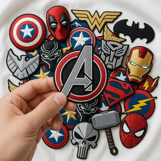 Hand Holding Avengers Logo Patch Above Marvel, DC Superhero Patches