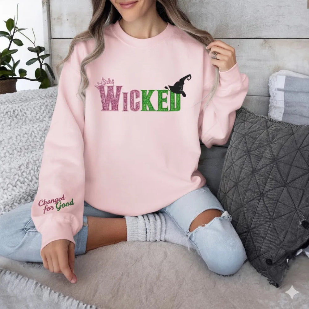 Pink "Wicked" Embroidered Sweatshirt Worn Casually On Couch.