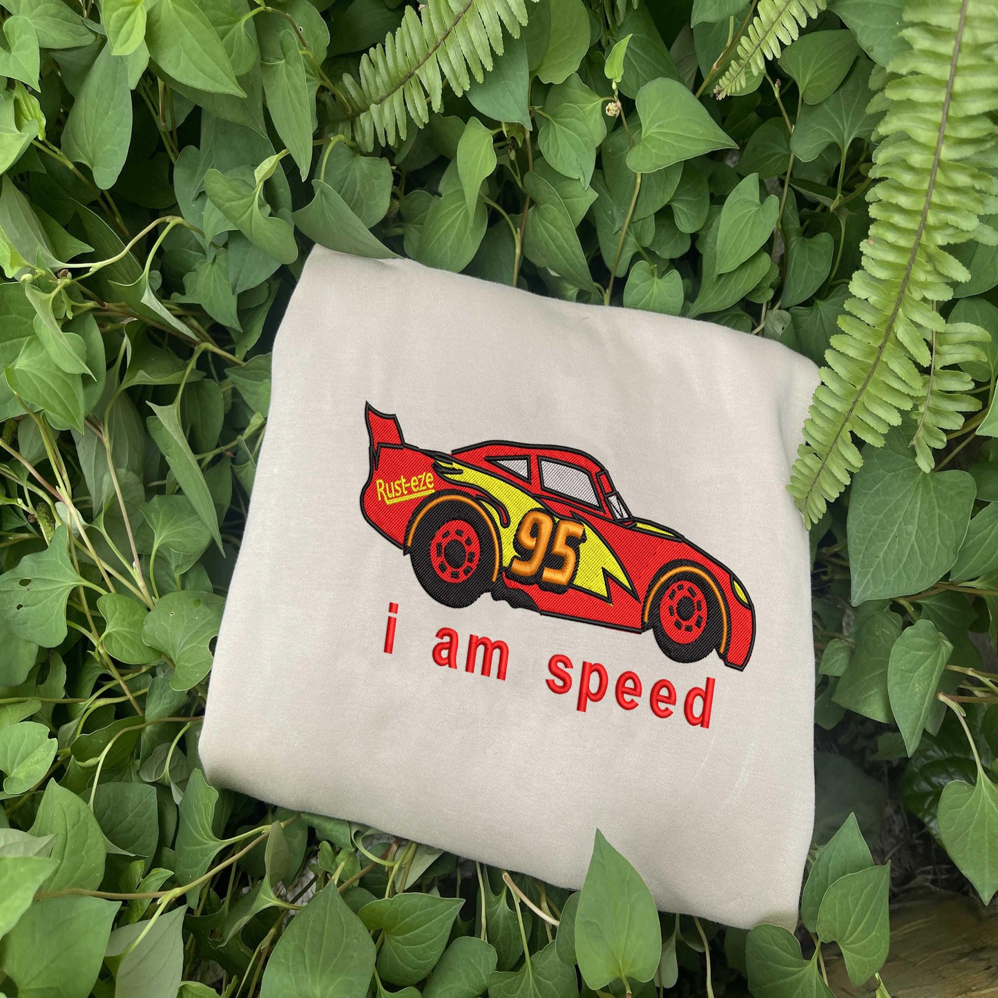 Sand Lightning McQueen Sweatshirt On Green Leaves.