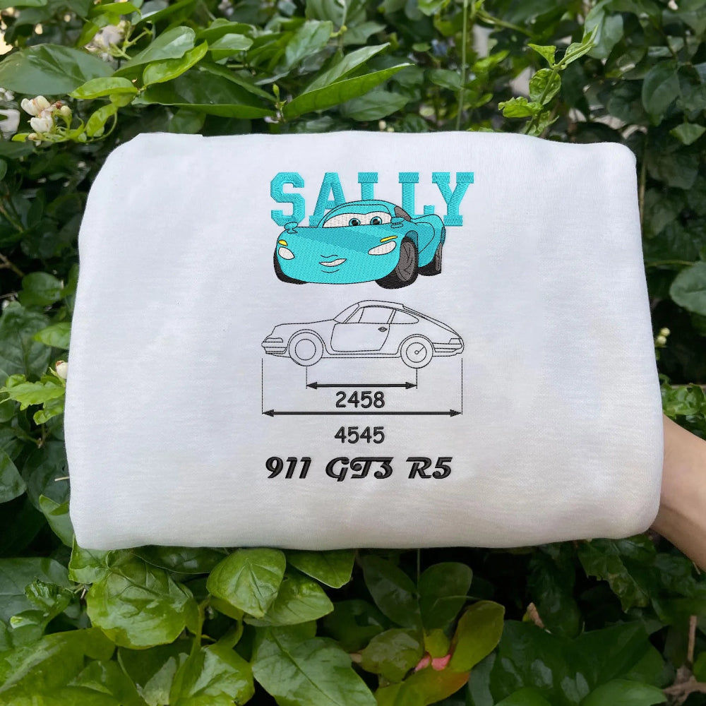 Folded White Sweatshirt Showing Embroidered Mater Tow Truck Blueprint Design