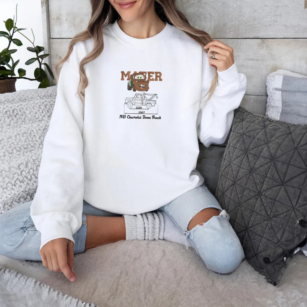 Woman Wearing Mater Embroidered Sweatshirt In Cozy Indoor Setting