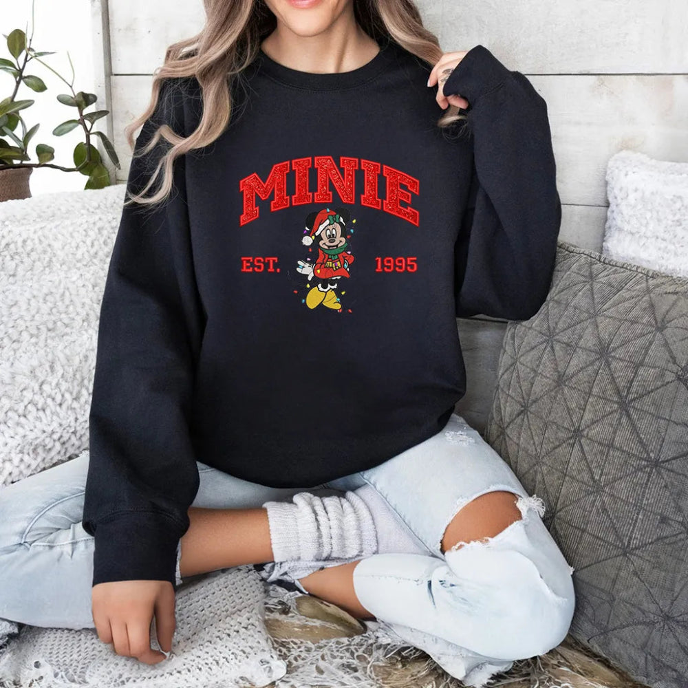 Woman In Black Minnie Embroidered Sweatshirt Posing On Cozy Bed