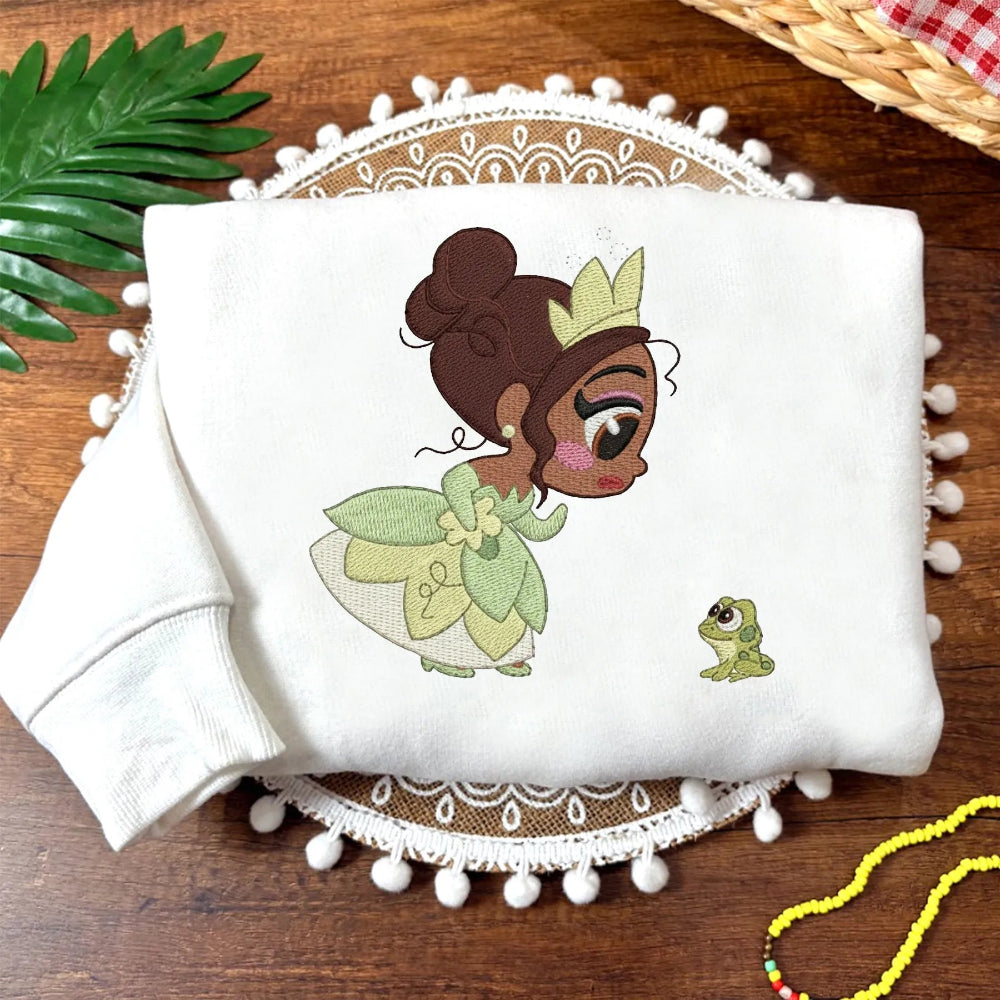 White Sweatshirt Showing Embroidered Chibi Tiana And Frog