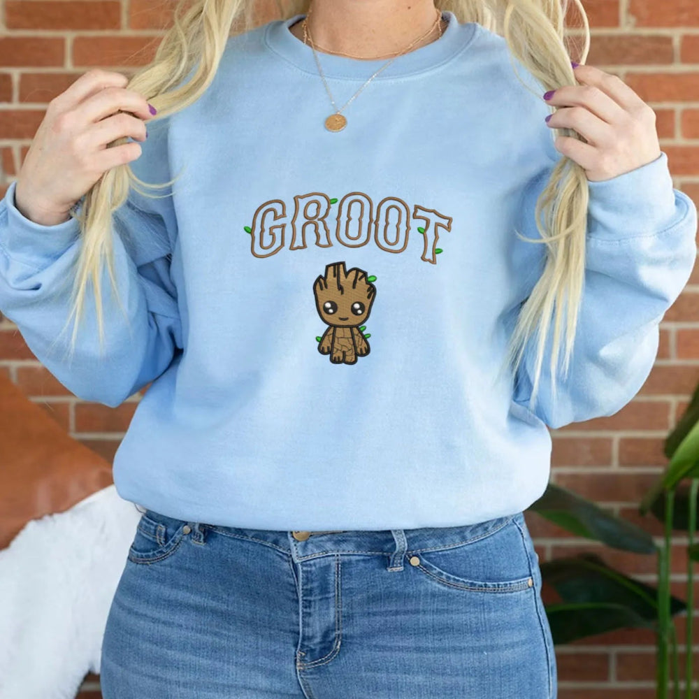 Light Blue Sweatshirt Worn By Woman Featuring Adorable Groot Embroidery