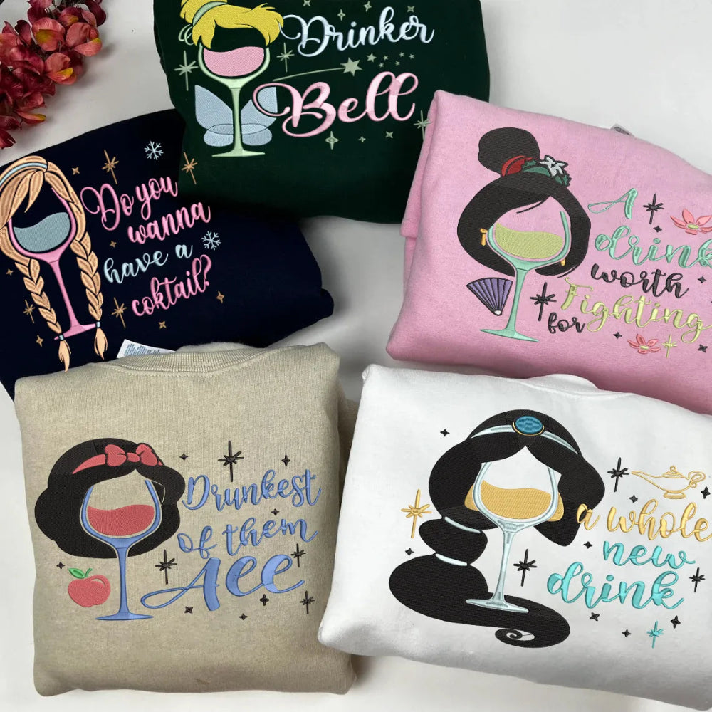 Collection Of Disney Princess Wine Pun Embroidered Sweatshirts Folded Together.