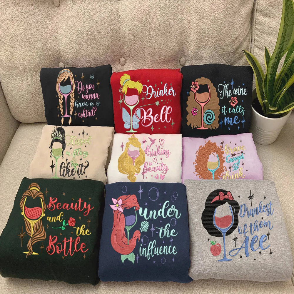 Collection Of Disney Princess Wine Pun Embroidered Sweatshirts Folded Together.