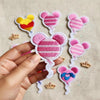 Hand Holding Pink Striped Minnie Mouse Balloon Embroidered Patch Close-Up.