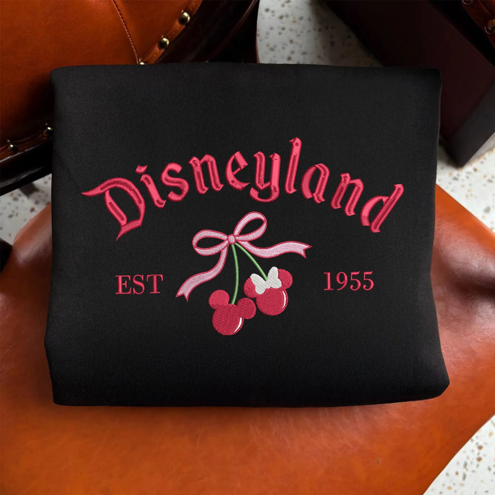 Folded Black Disneyland Sweatshirt With Pink Embroidered Cherry Minnie Bow