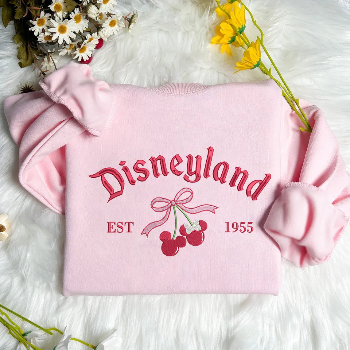 Pink Disneyland Sweatshirt Featuring Embroidered Text And Minnie Cherry Motif