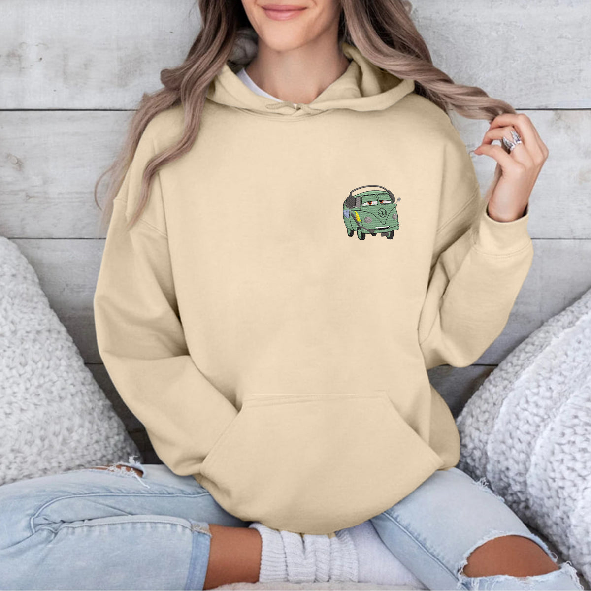 Model Wearing Embroidered Hoodie With Green Jeans.