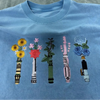 Light Blue T-Shirt Highlighting Bright Floral Lightsaber Crew Design