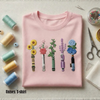 Light Pink Folded Unisex T-Shirt Displaying Embroidered Flower Lightsabers 