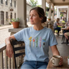 T-Shirt Worn By Woman Featuring Colorful Floral Lightsaber Embroidery
