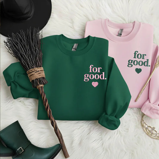 Split Wicked For Good sweater with stitched heart sigil.