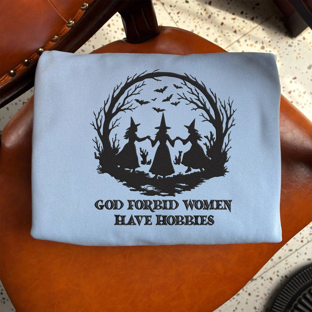 Light Blue Sweatshirt Folded Showing Dark Witch Forest And Quote