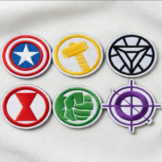 Six Marvel Avengers Symbol Embroidered Patches On White Fabric
