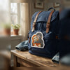 Two Baby Monkeys Patch Applied On Blue Backpack On Wooden Table.