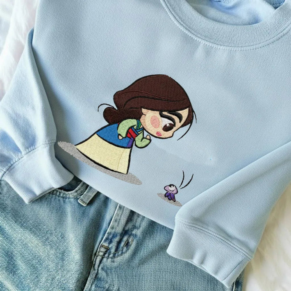 Light Blue Sweatshirt Showcasing Sweet Chibi Mulan, Curious Cri-Kee Design