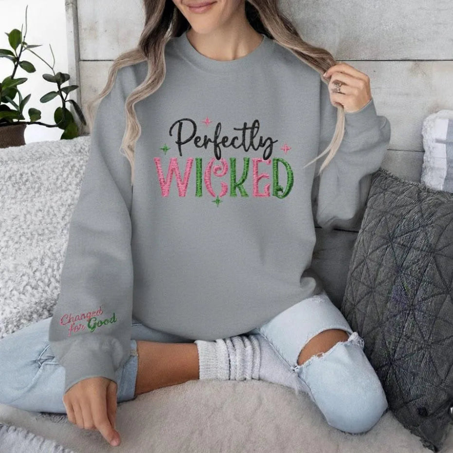 Grey "Perfectly Wicked" Embroidered Sweatshirt Modeled On Couch.