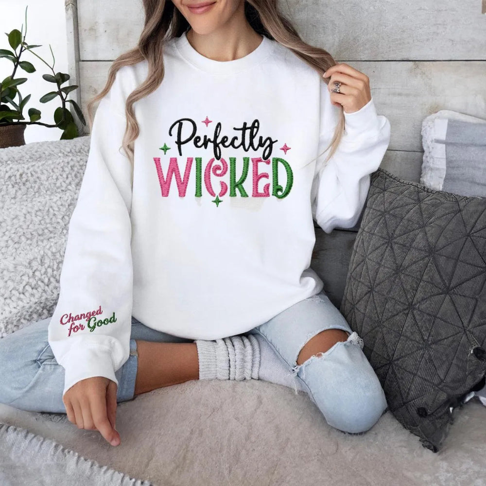 White "Perfectly Wicked" Embroidered Sweatshirt In Cozy Setting.