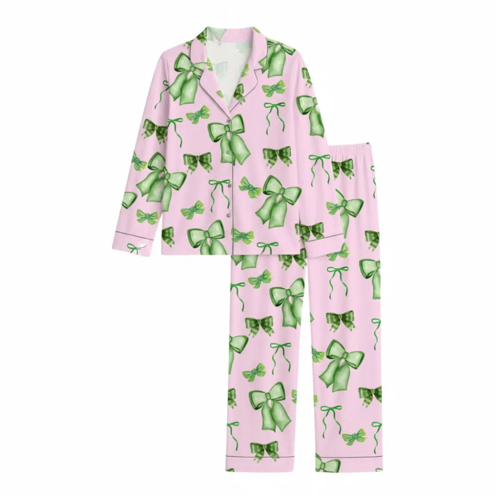 Pink Bow Pajamas With Long Sleeves On Bed.