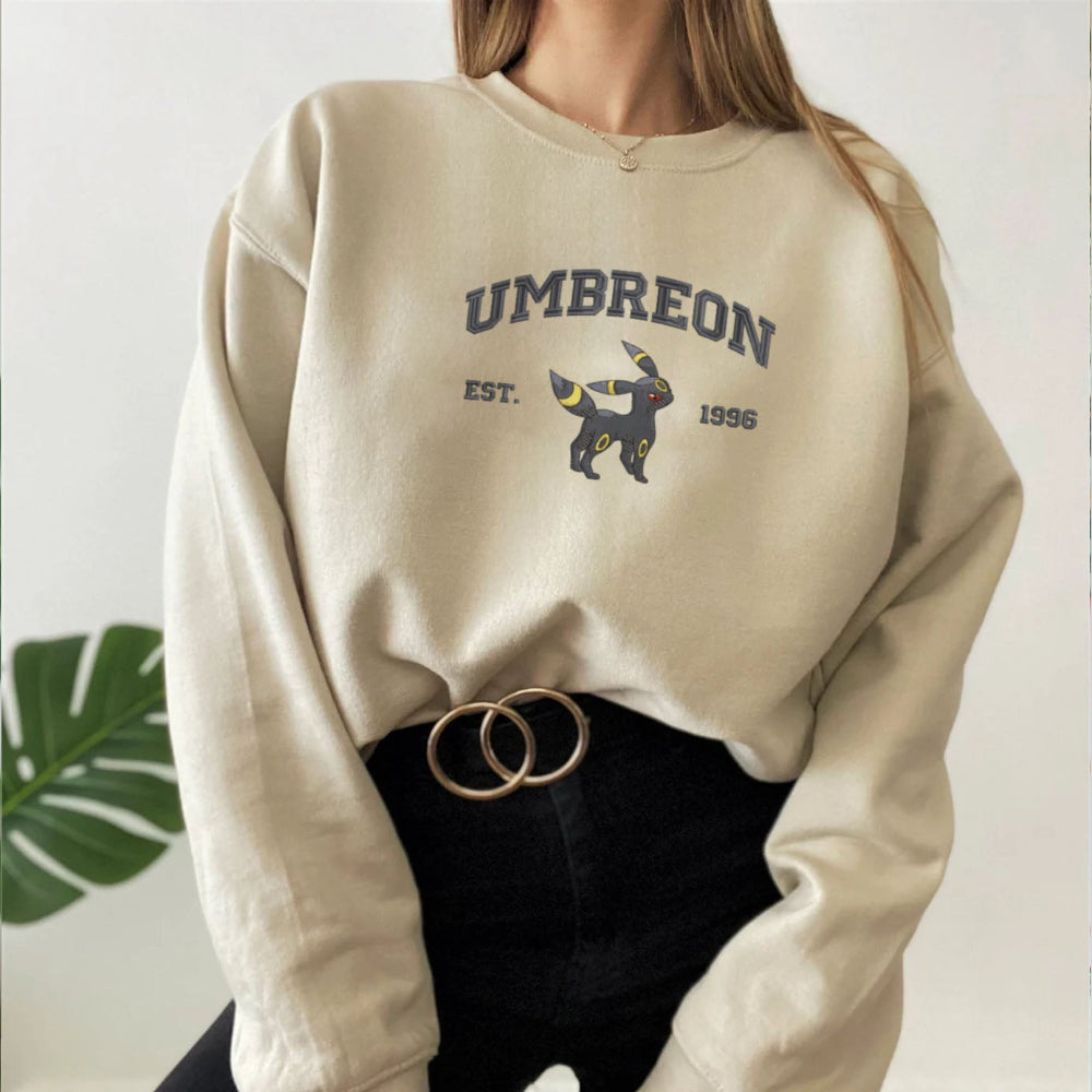 Model Wearing Umbreon Embroidered Pokemon Sweatshirt In Sand.