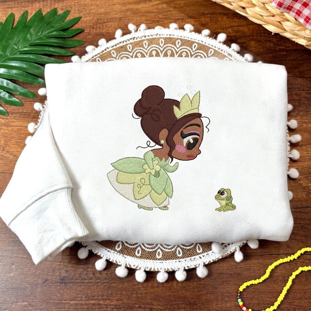 White Folded Sweatshirt Showing Cute Tiana Fairy And Frog Patch