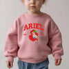 Toddler Wearing Pink Ariel Embroidered Sweatshirt With Red Varsity Text