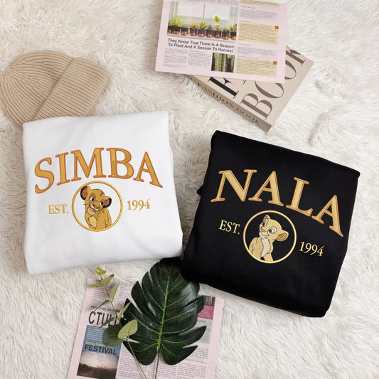 Folded Lion King Simba, Nala Varsity Sweatshirts On Fuzzy Surface
