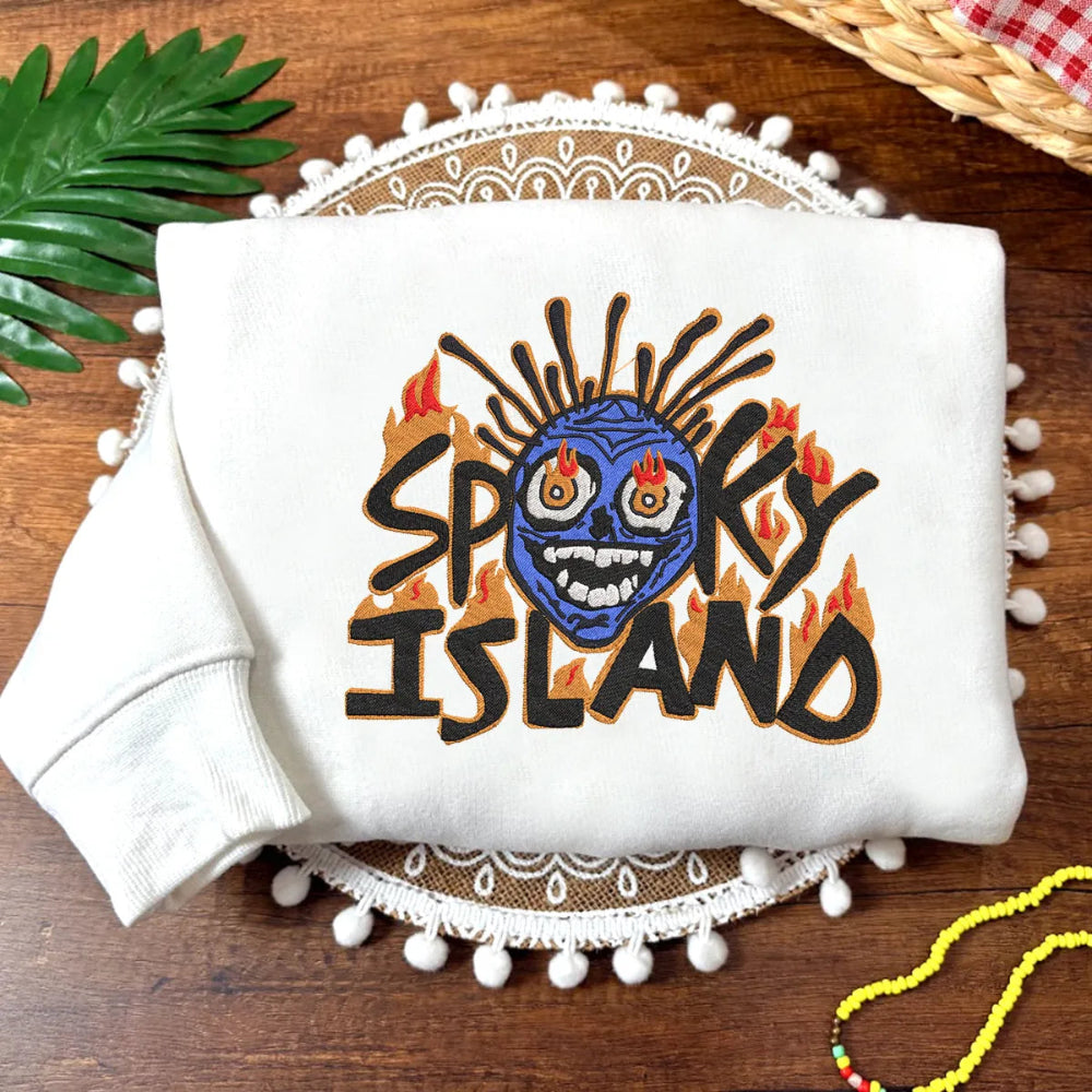 White Sweatshirt With Spooky Island Embroidered Monster On Table