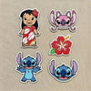Hands Holding Collection Of Stitch Angel Lilo Hibiscus Iron-On Patches