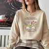 Sweatshirt Worn By Woman With Embroidered Open Book And Flowers