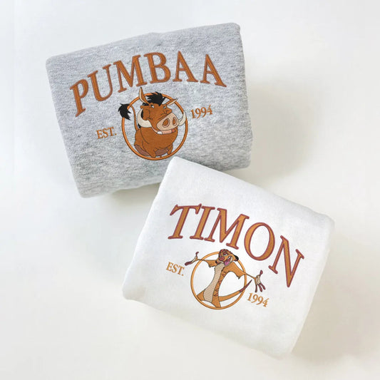 Folded Sweatshirts With Pumbaa And Timon Embroidered Est 1994