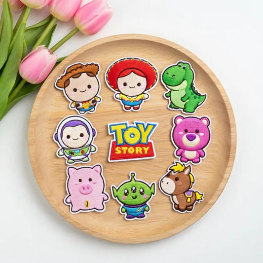 Wooden Tray Displaying Nine Cute Toy Story Character Embroidered Patches
