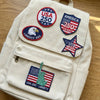 Sand Backpack Adorned With Multiple USA 250 Years Patriotic Patches
