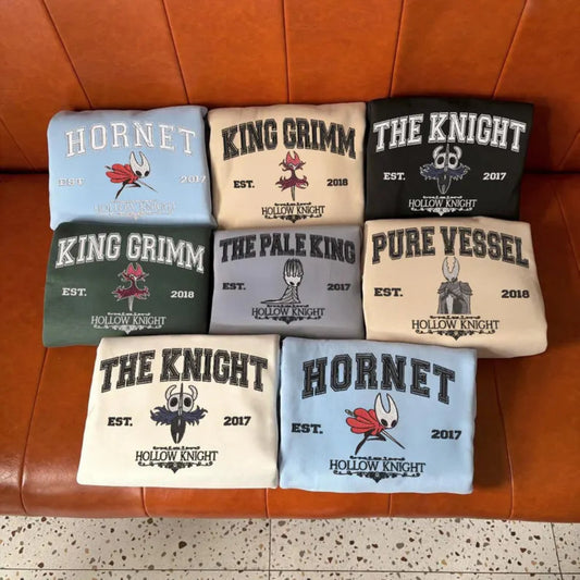 Assorted Hollow Knight Character Sweatshirts On Couch
